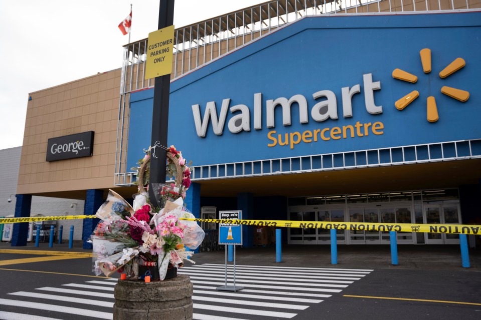Floral memorial outside a closed Walmart Supercentre.