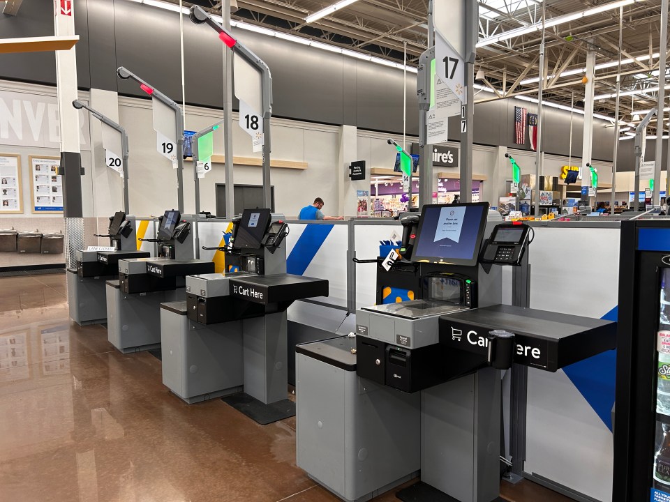 Self-checkout kiosks in a Walmart store.
