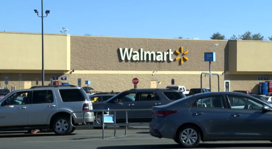 Walmart store exterior with cars in the parking lot.