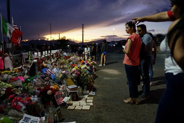 EL PASO, TX - AUGUST 15: People gather at a makeshift memorial honoring victims outside Walmart August 15, 2019 in El Paso, Texas. 22 people were killed in the Walmart during a mass shooting on August 3rd. A 21-year-old white male suspect remains in custody in El Paso which sits along the U.S.-Mexico border. (Photo by Sandy Huffaker/Getty Images)