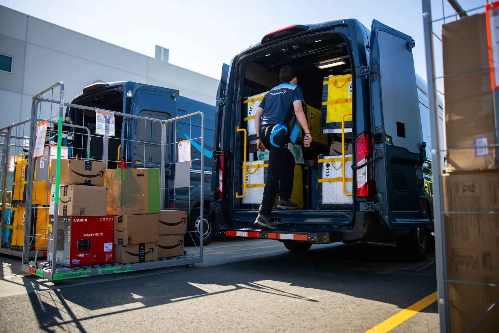 An Amazon driver loads a delivery van.