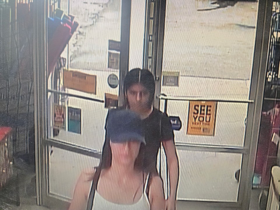 Security camera image of two people leaving a store.
