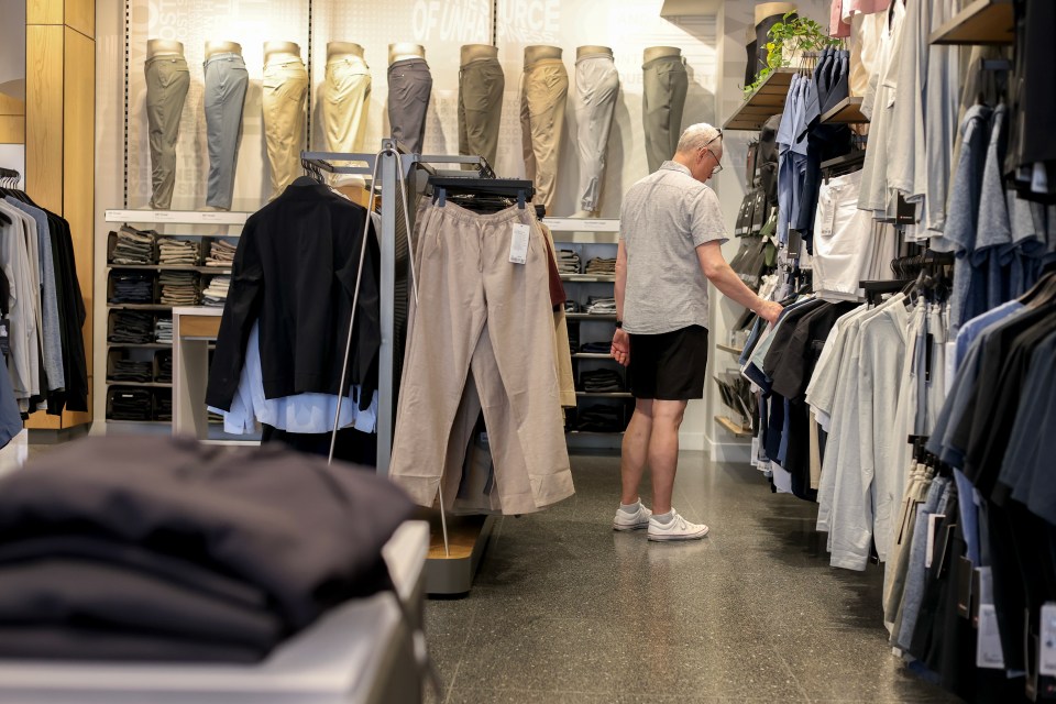 A man shops for clothes in a Lululemon store.