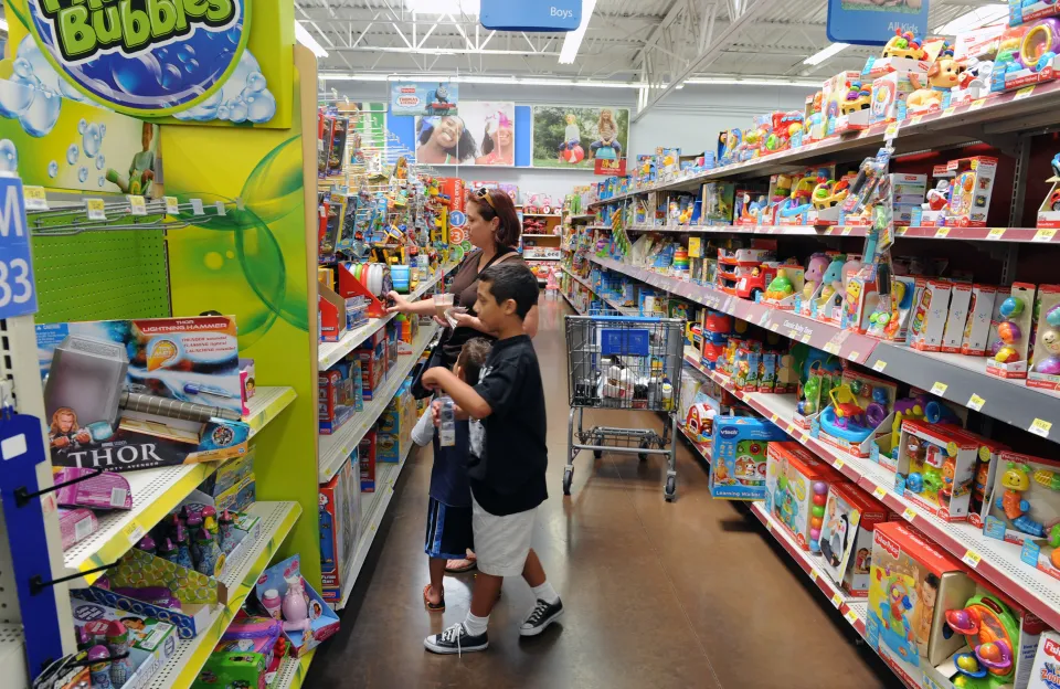 A mother and her two sons shop for toys at a Walmart.