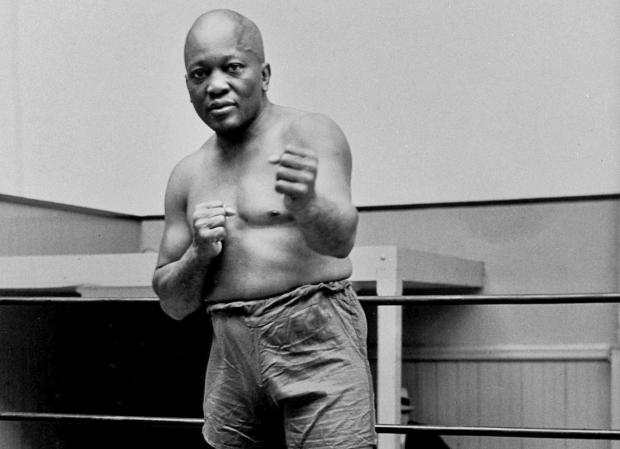 FILE - Boxer Jack Johnson, the first black world heavyweight champion, poses in New York City, 1932. (AP Photo/File)