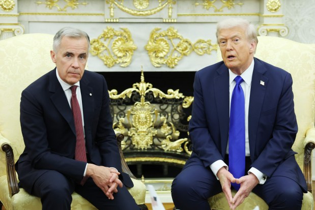 President Donald Trump and Canadian Prime Minister Mark Carney speak to reporters in the Oval Office of the White House on October 07, 2025 in Washington, DC.