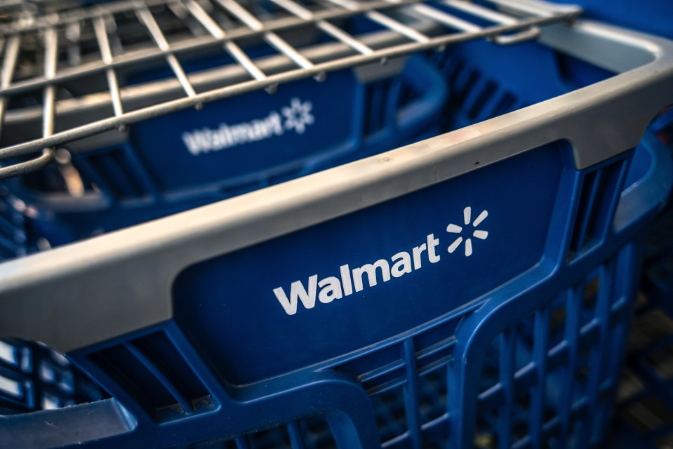 Close-up of a blue Walmart shopping cart with the white Walmart logo and sparkling star.