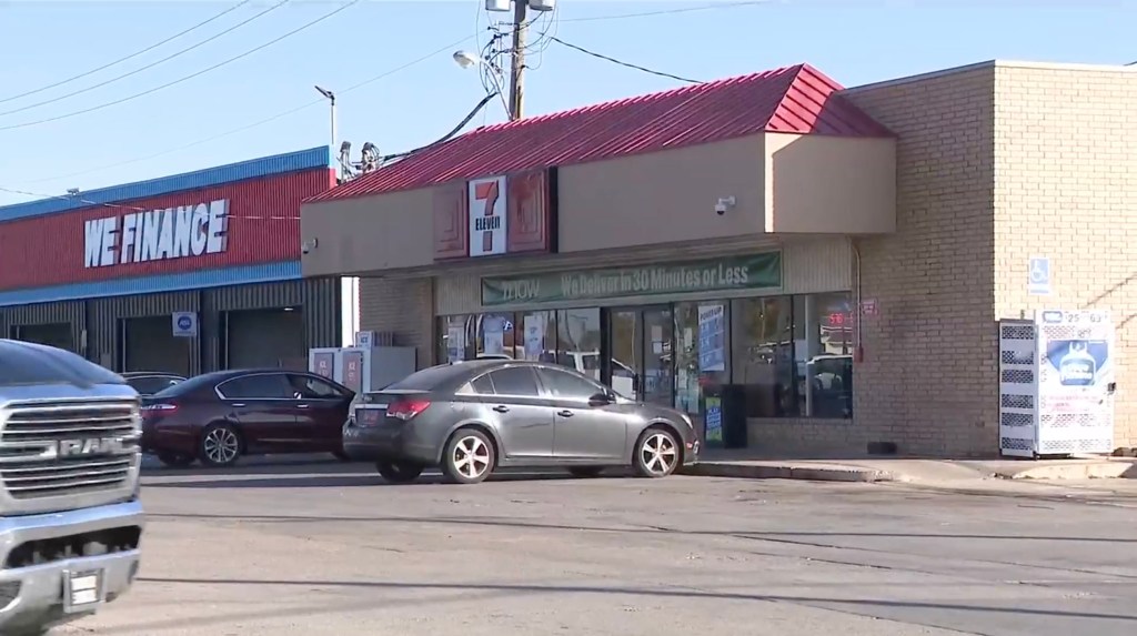 A street view showing a 7-Eleven store with a red roof next to a