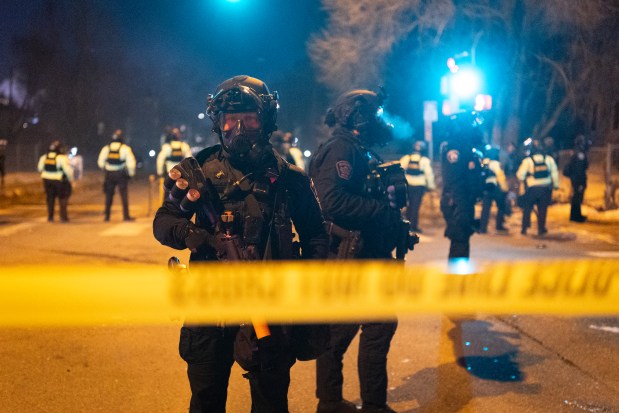 Minneapolis and Minnesota State police guard a perimeter following a shooting incident with federal agents on January 14, 2026 in Minneapolis, Minnesota.