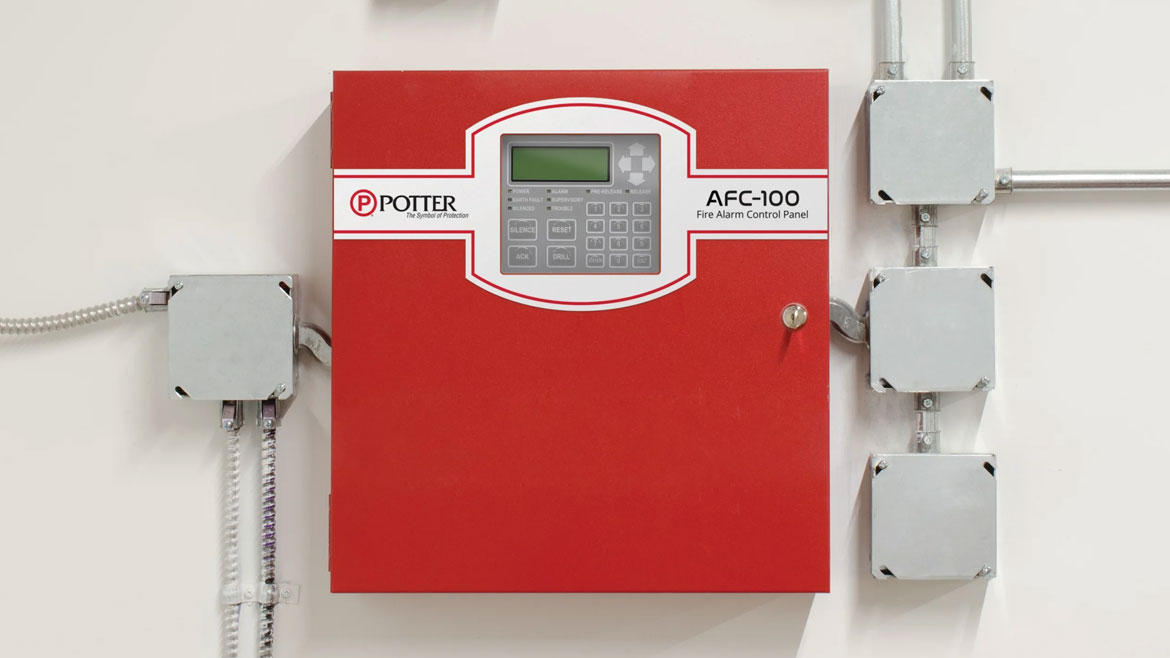A red Potter AFC-100 fire alarm control panel with a speaker, junction boxes, and conduits on a white wall.